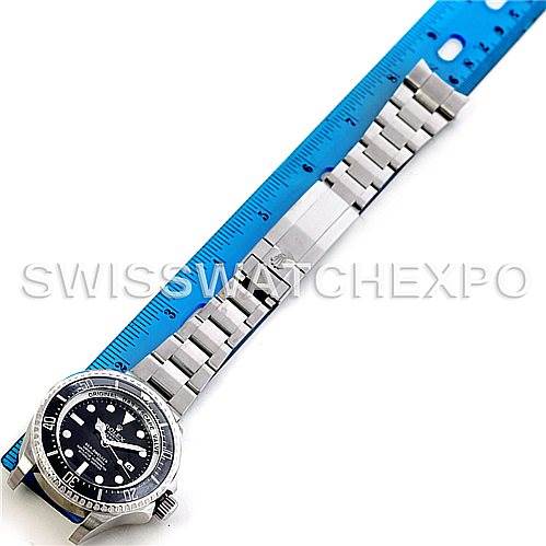 The image shows the Rolex Sea-Dweller 116660 Men's Stainless Steel Black Dial 116660 Men's Stainless Steel Black Dial watch laying flat with its stainless steel bracelet and a blue ruler for measurement.