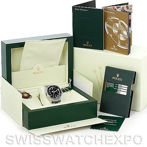 This image shows a Rolex Sea-Dweller 116660 Men's Stainless Steel Black Dial 116660 Men's Stainless Steel Black Dial watch from a front angle, displayed within its box, along with manuals, tags, and a cleaning cloth.