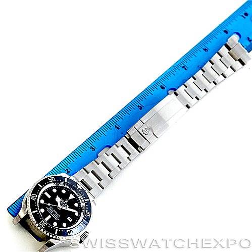 The image shows a Rolex Sea-Dweller 116660 Men's Stainless Steel Black Dial 116660 Men's Stainless Steel Black Dial watch laid flat alongside a blue ruler, highlighting the watch face, bezel, and metal bracelet.