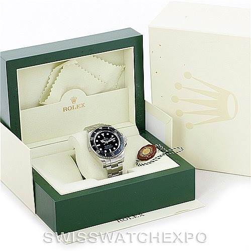 The image shows a Rolex Sea-Dweller 116660 Men's Stainless Steel Black Dial 116660 Men's Stainless Steel Black Dial watch and accessories in an open green and cream-colored box with the Rolex logo.