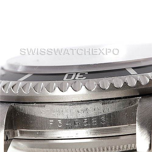 This image shows a close-up of the bezel and case side of a Rolex Sea-Dweller 16600 Men's Stainless Steel Black Dial 16600 Men's Stainless Steel Black Dial watch, highlighting the "STAINLESS STEEL" engraving and serial number.