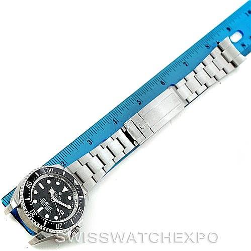 The Rolex Sea-Dweller 116660 Men's Stainless Steel Black Dial 116660 Men's Stainless Steel Black Dial watch is shown from a top-down angle alongside a ruler, highlighting the bracelet and dial.