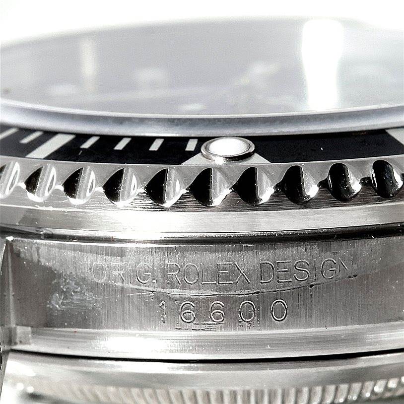 This close-up image of a Rolex Sea-Dweller 16600 Men's Stainless Steel Black Dial 16600 Men's Stainless Steel Black Dial watch shows the bezel, crystal, and case with the model number 16600 engraved.