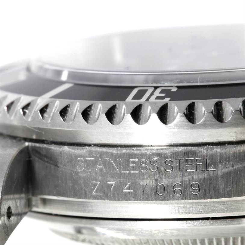 The image shows a close-up of the side bezel and part of the case of a Rolex Sea-Dweller 16600 Men's Stainless Steel Black Dial 16600 Men's Stainless Steel Black Dial watch, highlighting the serial number.
