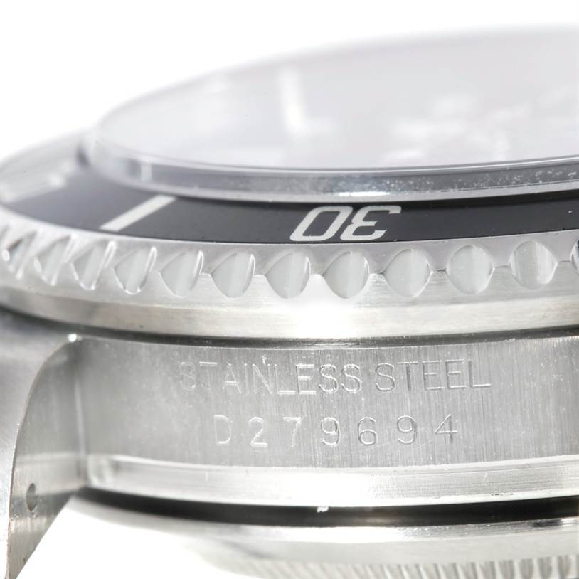The image shows a close-up angle of the bezel, case, and part of the crystal of a Rolex Sea-Dweller 16600 Men
s Stainless Steel Black Dial 16600 Men
s Stainless Steel Black Dial watch, highlighting the serial number.
