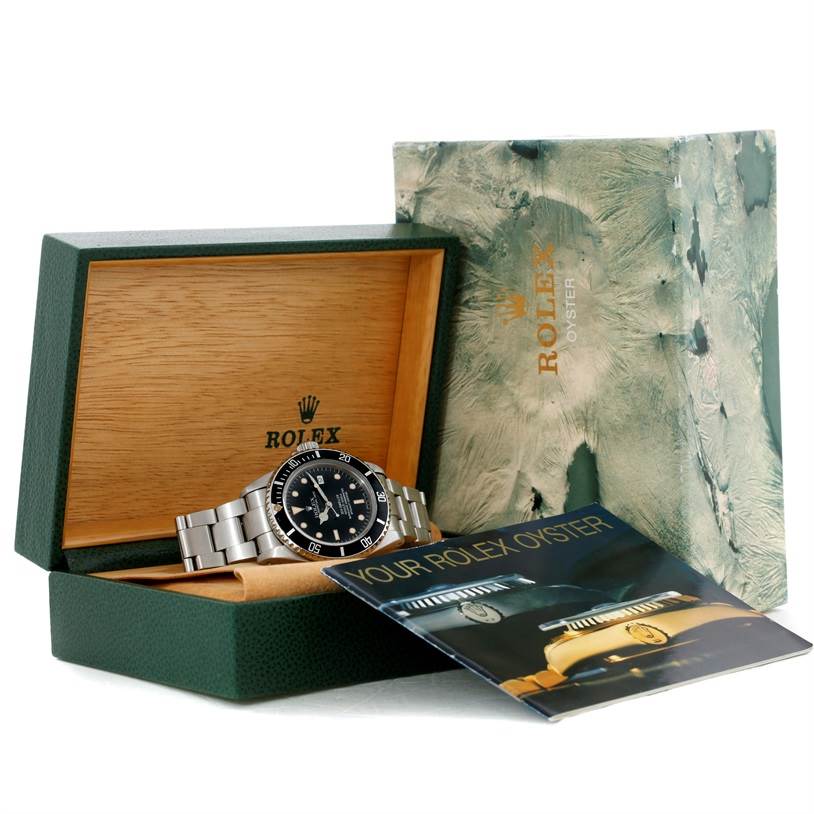 The Rolex Sea-Dweller 16660 Men's Stainless Steel Black Dial 16660 Men's Stainless Steel Black Dial watch is shown in its open display box, alongside its outer box and an informational booklet.