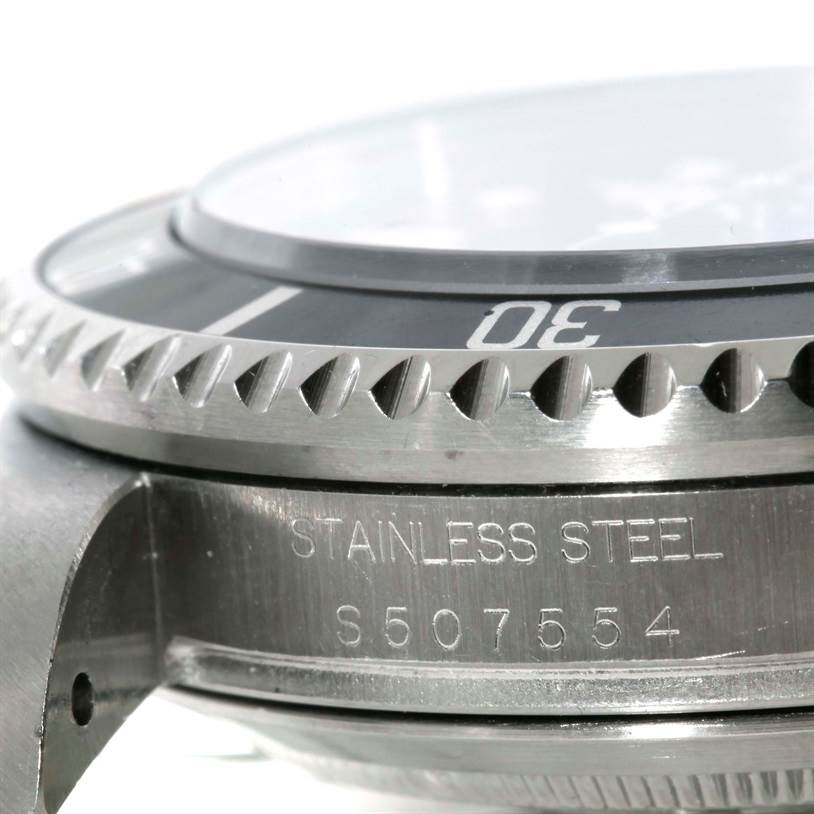This close-up of the Rolex Sea-Dweller 16600 Men's Stainless Steel Black Dial 16600 Men's Stainless Steel Black Dial shows the side of the watch case, bezel edge, and serial number engraving.