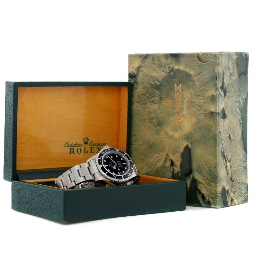 The image shows a Rolex Sea-Dweller 16600 Men's Stainless Steel Black Dial 16600 Men's Stainless Steel Black Dial watch placed at an angle inside its green and wooden Rolex box, next to the outer green marbleized box.