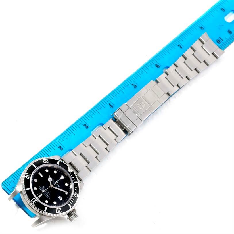 This image shows the full view of a Rolex Sea-Dweller 16600 Men's Stainless Steel Black Dial 16600 Men's Stainless Steel Black Dial watch, including the face, bezel, bracelet, clasp, and part of a ruler.