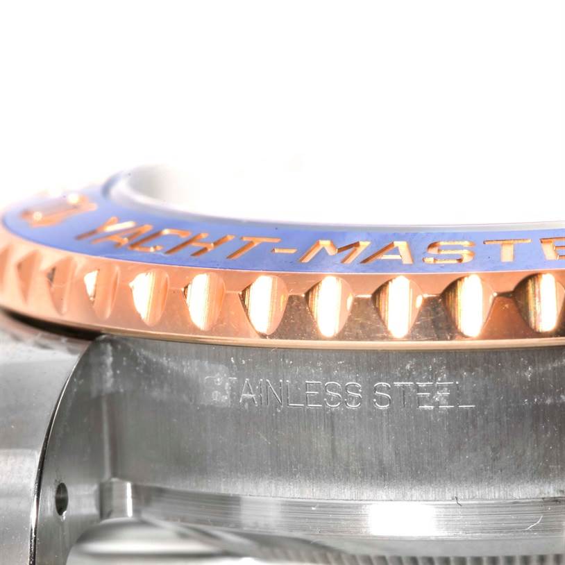 The image shows a close-up side angle of the Rolex Yacht-Master 116681 Men's Steel and Gold (two tone) White Dial 116681 Men's Steel and Gold (two tone) White Dial model, highlighting the bezel and part of the case.