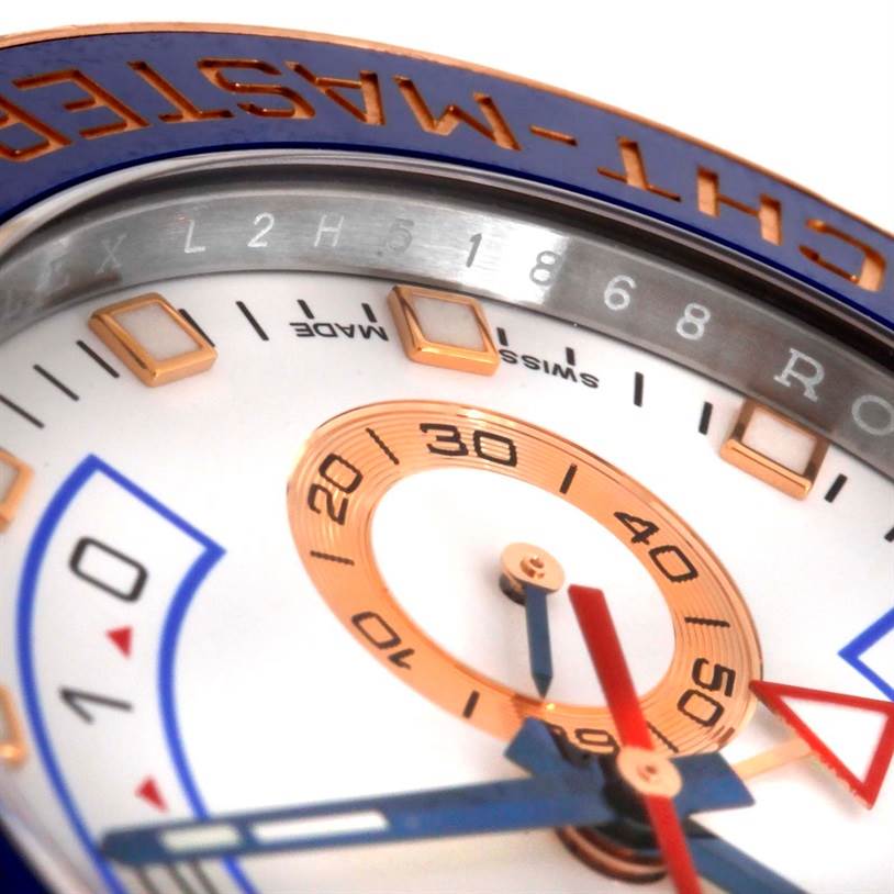 This close-up shot of the Rolex Yacht-Master 116681 Men's Steel and Gold (two tone) White Dial 116681 Men's Steel and Gold (two tone) White Dial watch shows the bezel, part of the dial, and the hour markers.