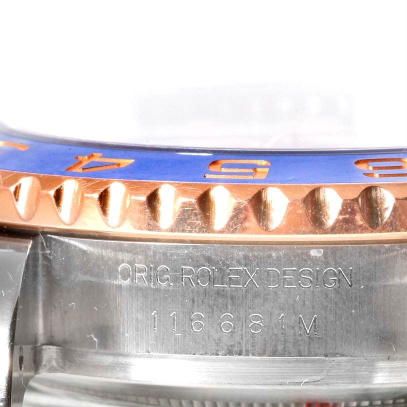 This close-up image shows the bezel and case edge of a Rolex Yacht-Master 116681 Men's Steel and Gold (two tone) White Dial 116681 Men's Steel and Gold (two tone) White Dial watch, featuring its model number and design engraving.