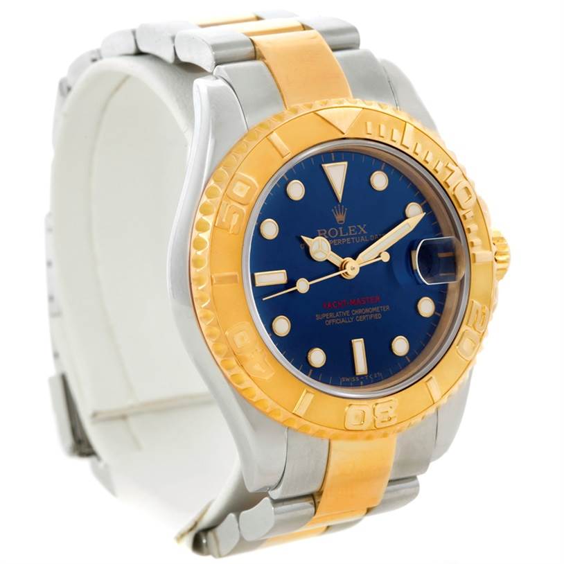 The image shows a Rolex Yacht-Master 68623 Men's Stainless Steel Blue Dial 68623 Men's Stainless Steel Blue Dial watch at an angled view, highlighting its gold bezel, blue dial, and two-tone bracelet.