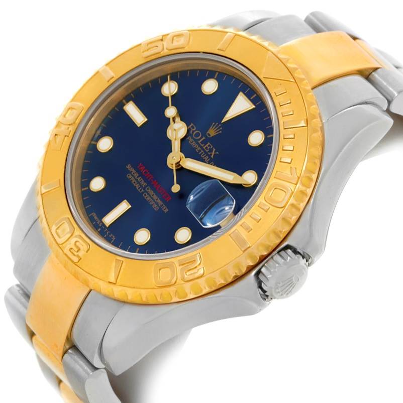 This Rolex Yacht-Master 68623 Men's Stainless Steel Blue Dial 68623 Men's Stainless Steel Blue Dial watch is shown at a slight side angle, highlighting its gold bezel, blue dial, and metal bracelet.
