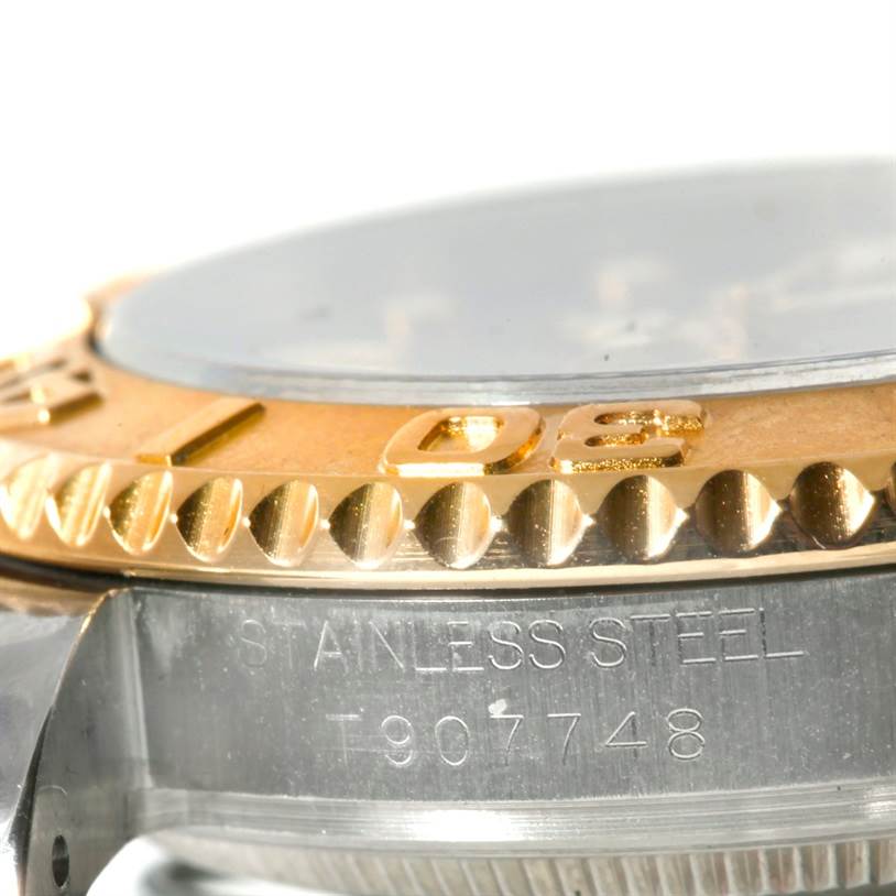 This close-up shows the bezel and part of the stainless steel casing with an engraved serial number of the Rolex Yacht-Master 68623 Men's Stainless Steel Blue Dial 68623 Men's Stainless Steel Blue Dial watch.