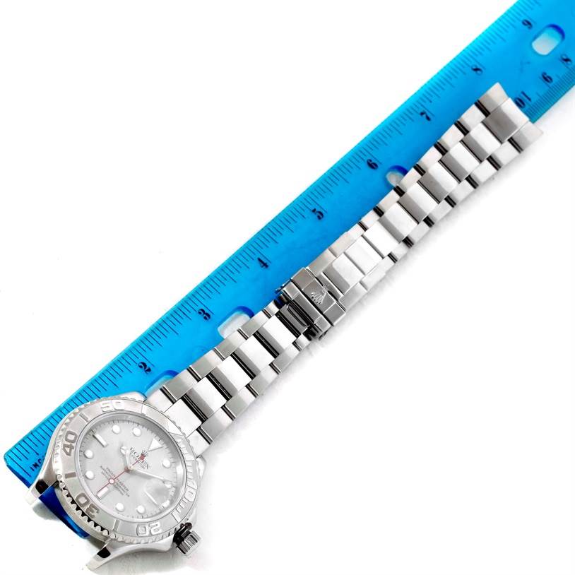 The image shows a Rolex Yacht-Master 16622 Men's Stainless Steel Silver Dial 16622 Men's Stainless Steel Silver Dial watch horizontally, with its bracelet laid out next to a blue ruler for measurement.