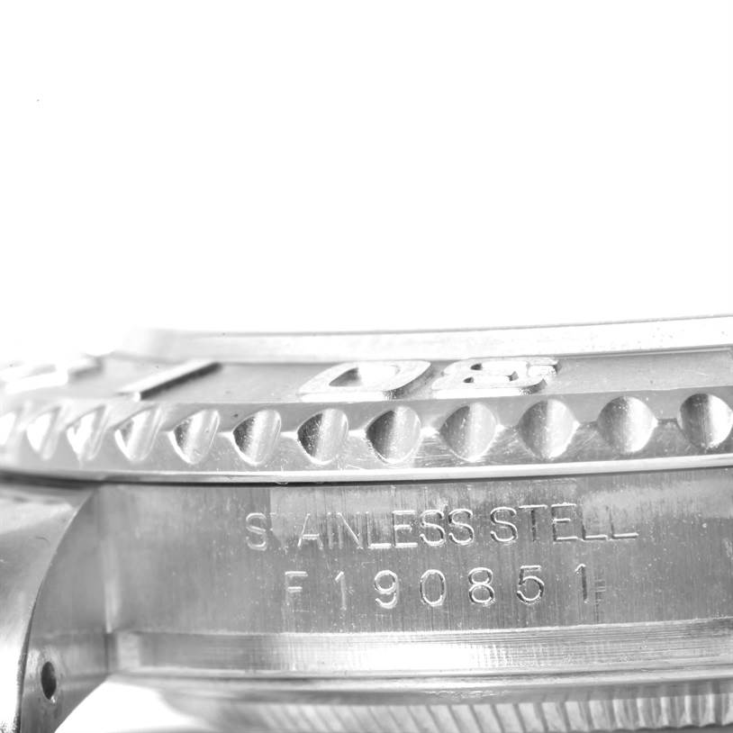 The image shows a close-up angle of the Rolex Yacht-Master 16622 Men's Stainless Steel Silver Dial 16622 Men's Stainless Steel Silver Dial watch bezel and part of the case with engravings.