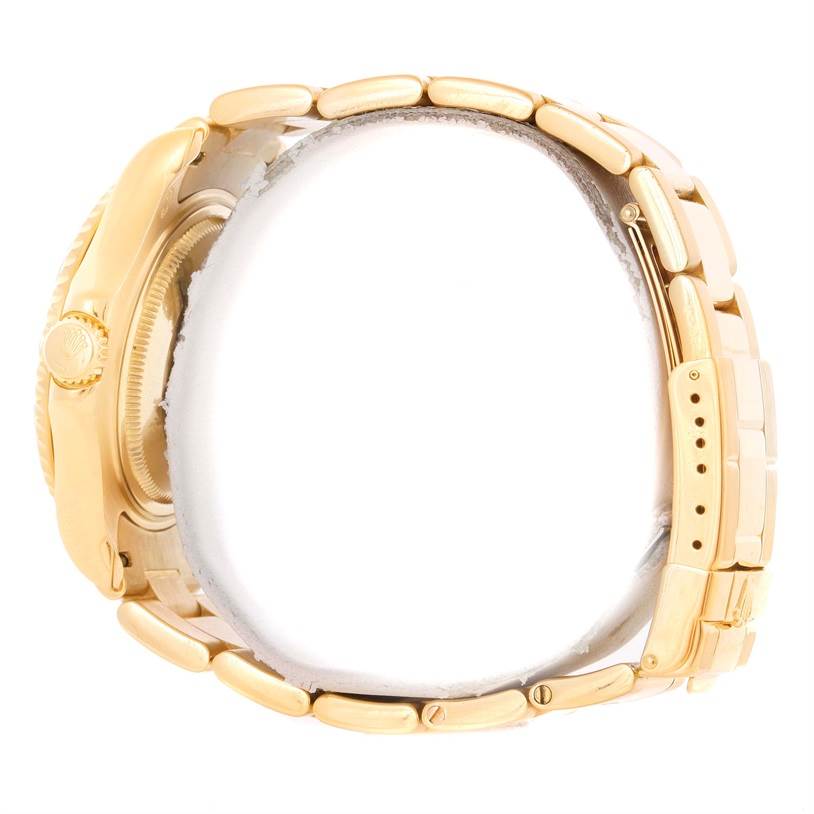 This is a side view of a Rolex Yacht-Master 68628 Men's Yellow Gold White Dial 68628 Men's Yellow Gold White Dial watch, showing the crown, case, and bracelet links.