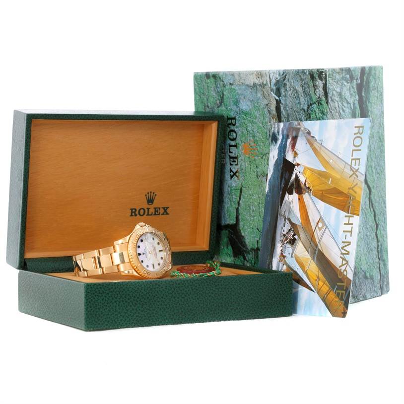 The Rolex Yacht-Master 68628 Men's Yellow Gold White Dial 68628 Men's Yellow Gold White Dial watch is shown at a slight angle inside its open green and wooden box, with the manual and exterior box displayed.