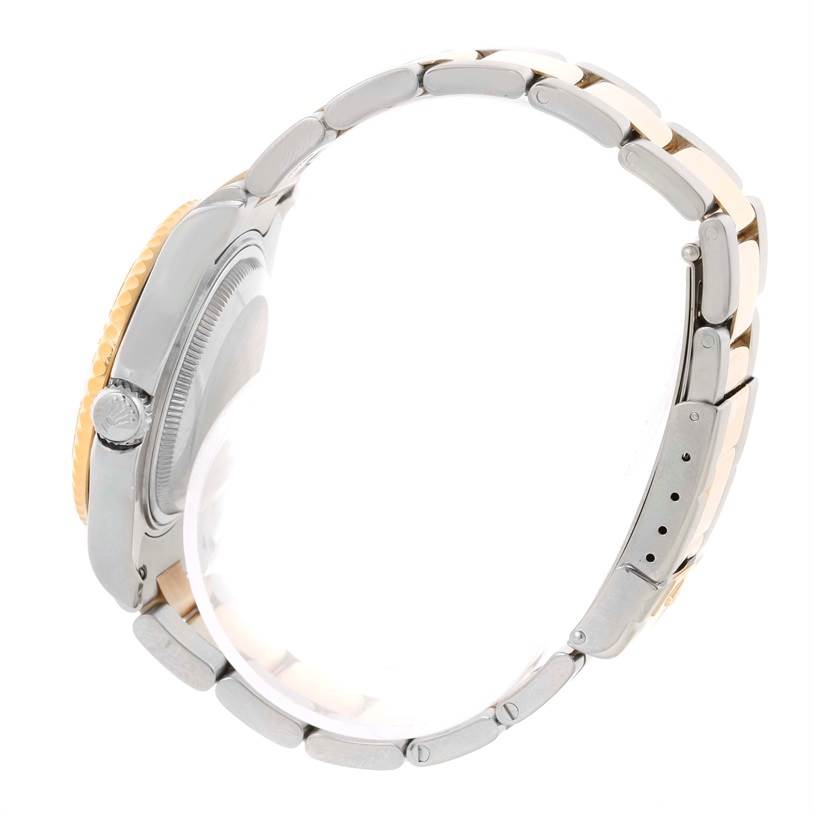 The side view of the Rolex Yacht-Master 68623 Men's Stainless Steel Blue Dial 68623 Men's Stainless Steel Blue Dial watch shows the crown, bezel, and part of the bracelet.