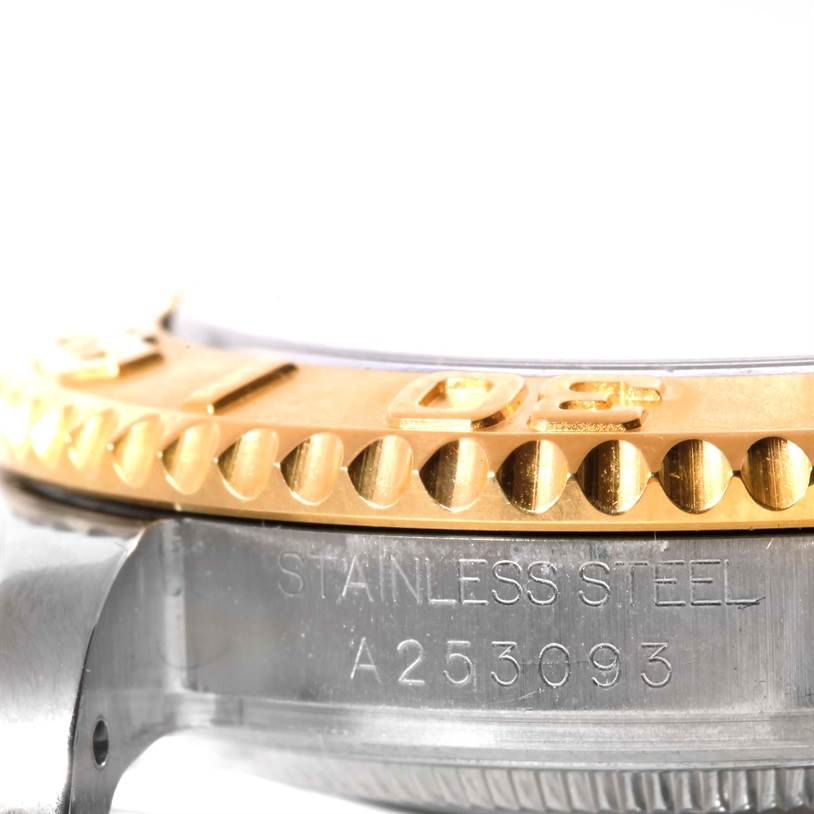 This close-up shows the side view of a Rolex Yacht-Master 68623 Men's Stainless Steel Blue Dial 68623 Men's Stainless Steel Blue Dial watch bezel and the engraved serial number on the stainless steel case.