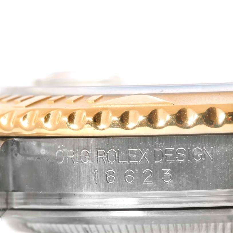 This close-up image of the Rolex Yacht-Master 16623 Men's Stainless Steel Champagne Dial 16623 Men's Stainless Steel Champagne Dial watch shows the side of the case, highlighting the bezel and engraved model number.