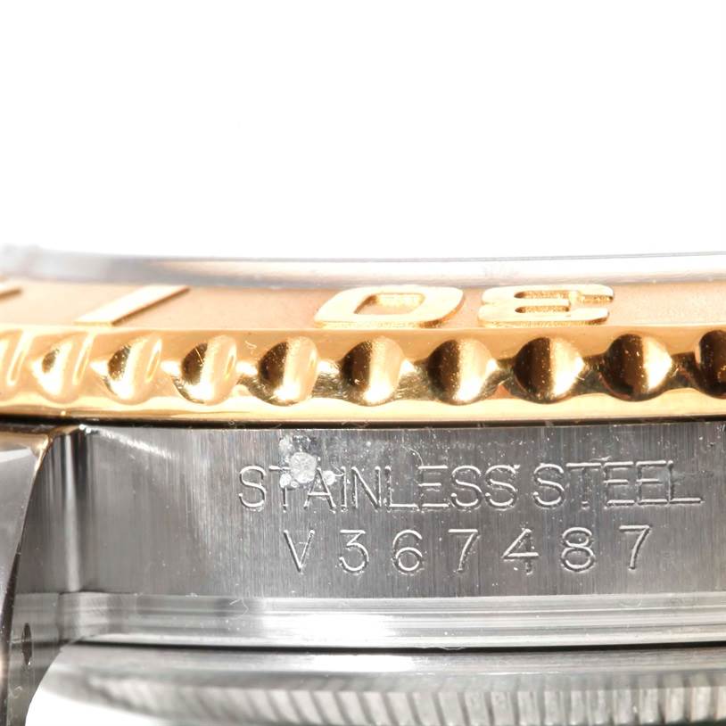 This close-up image shows the Rolex Yacht-Master 16623 Men's Stainless Steel Champagne Dial 16623 Men's Stainless Steel Champagne Dial’s stainless steel case and part of its gold bezel.