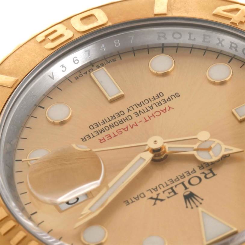 This is a close-up angle of a Rolex Yacht-Master 16623 Men's Stainless Steel Champagne Dial 16623 Men's Stainless Steel Champagne Dial dial, showcasing the hands, markers, date magnifier, and part of the bezel.