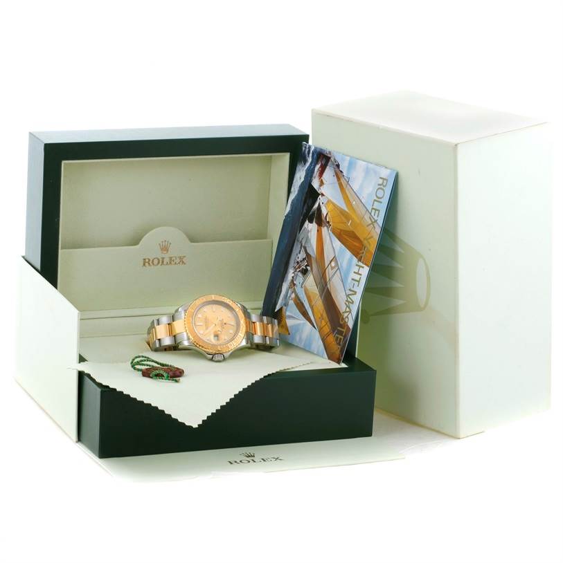 The image shows a Rolex Yacht-Master 16623 Men's Stainless Steel Champagne Dial 16623 Men's Stainless Steel Champagne Dial watch in a display box with a booklet and accessories.