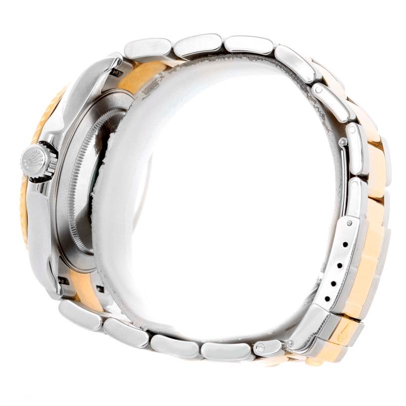 This side-angle view of the Rolex Yacht-Master 16623 Men's Stainless Steel White Dial 16623 Men's Stainless Steel White Dial watch shows the crown, side casing, and two-tone bracelet.