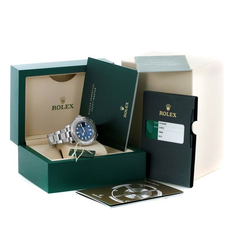 The image shows a Rolex Yacht-Master 116622 Men's Stainless Steel Blue Dial 116622 Men's Stainless Steel Blue Dial watch with its box, manuals, and authentication card at an oblique angle.