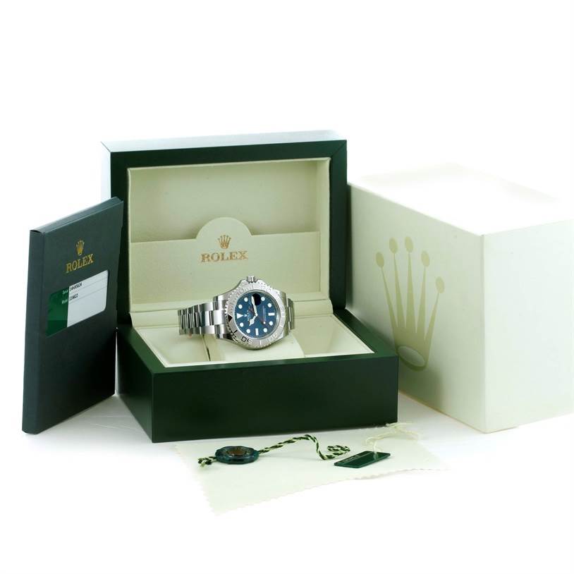 The Rolex Yacht-Master 116622 Men's Stainless Steel Blue Dial 116622 Men's Stainless Steel Blue Dial watch is shown in an open box along with its cardholder and accessories.