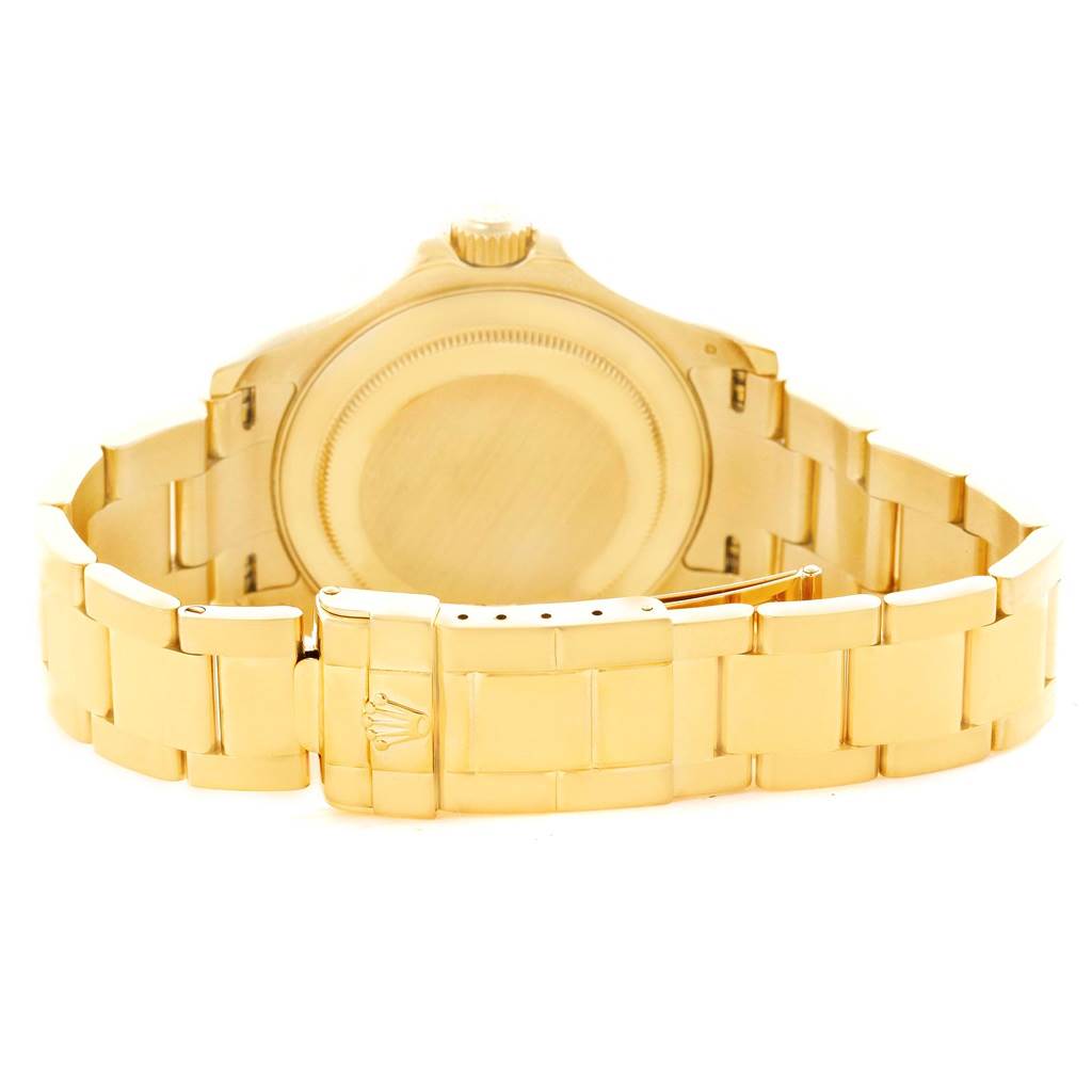 The image shows the back view of a Rolex Yacht-Master 16628 Men's Yellow Gold White Dial 16628 Men's Yellow Gold White Dial watch, highlighting its gold case back and bracelet.