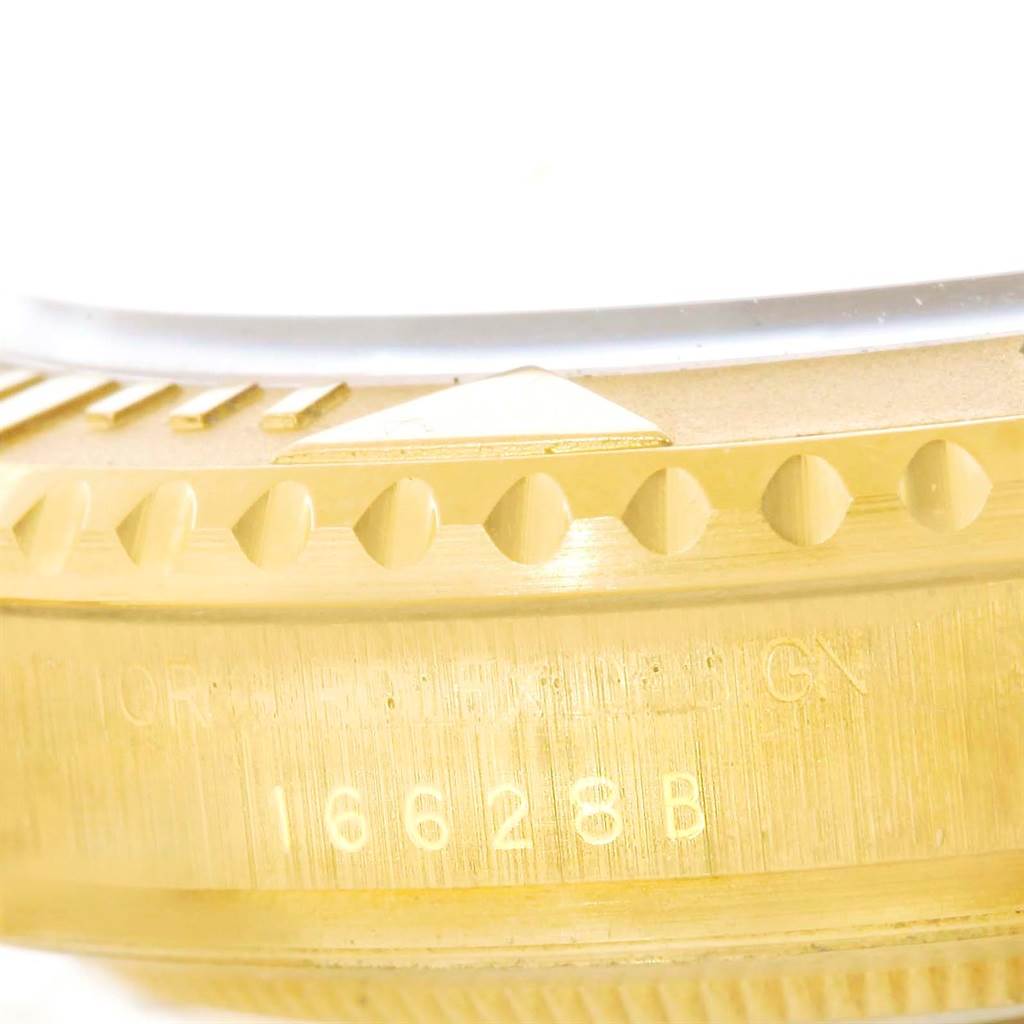 This close-up image shows the side of the bezel and case of a Rolex Yacht-Master 16628 Men's Yellow Gold White Dial 16628 Men's Yellow Gold White Dial watch, highlighting the model number 16628B.