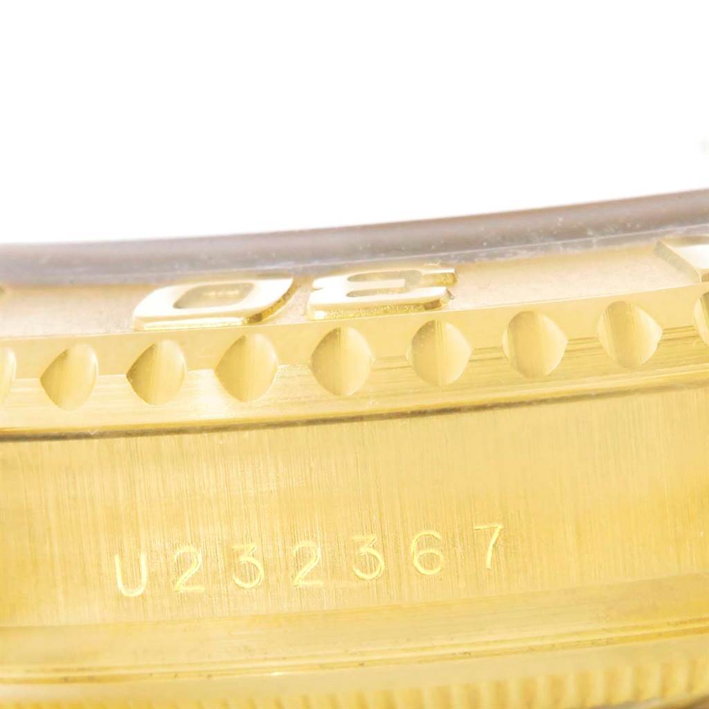 This close-up image shows a part of the bezel and the serial number of the Rolex Yacht-Master 16628 Men's Yellow Gold White Dial 16628 Men's Yellow Gold White Dial watch.