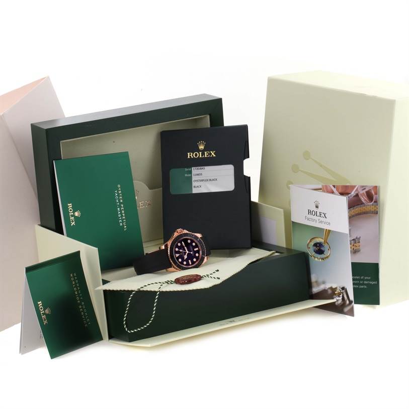 The image shows the Rolex Yacht-Master 116655 Men's Rose Gold Black Dial 116655 Men's Rose Gold Black Dial watch, its box, and accompanying booklets and cards at a front angle.