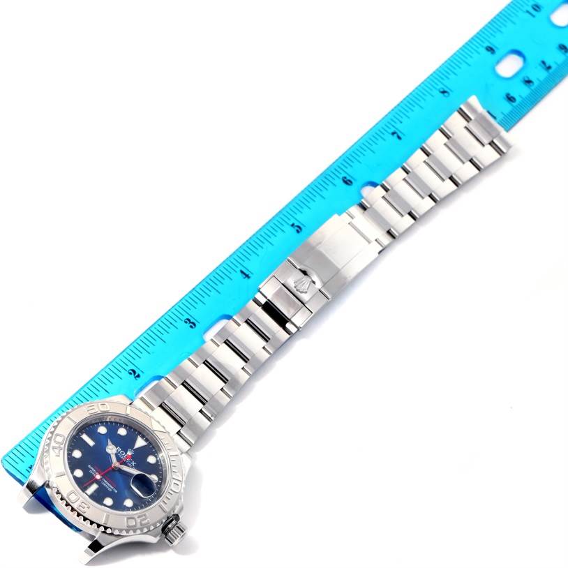 The image shows a Rolex Yacht-Master 116622 Men's Stainless Steel Blue Dial 116622 Men's Stainless Steel Blue Dial watch laid flat with its bracelet extended and measured against a blue ruler.