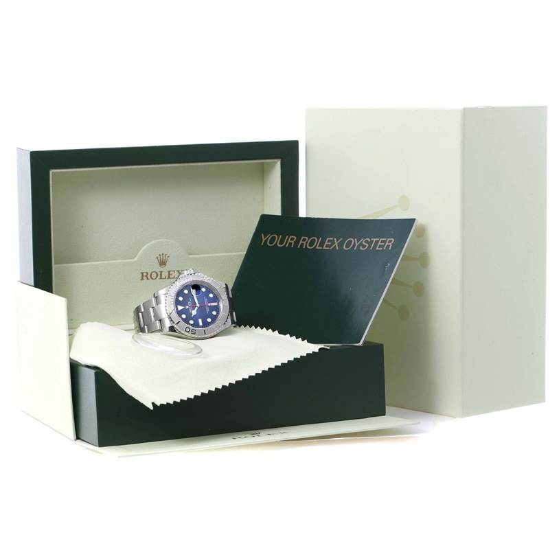 The image shows a Rolex Yacht-Master 116622 Men's Stainless Steel Blue Dial 116622 Men's Stainless Steel Blue Dial watch, its box, a booklet, and a cleaning cloth angled slightly from the front.