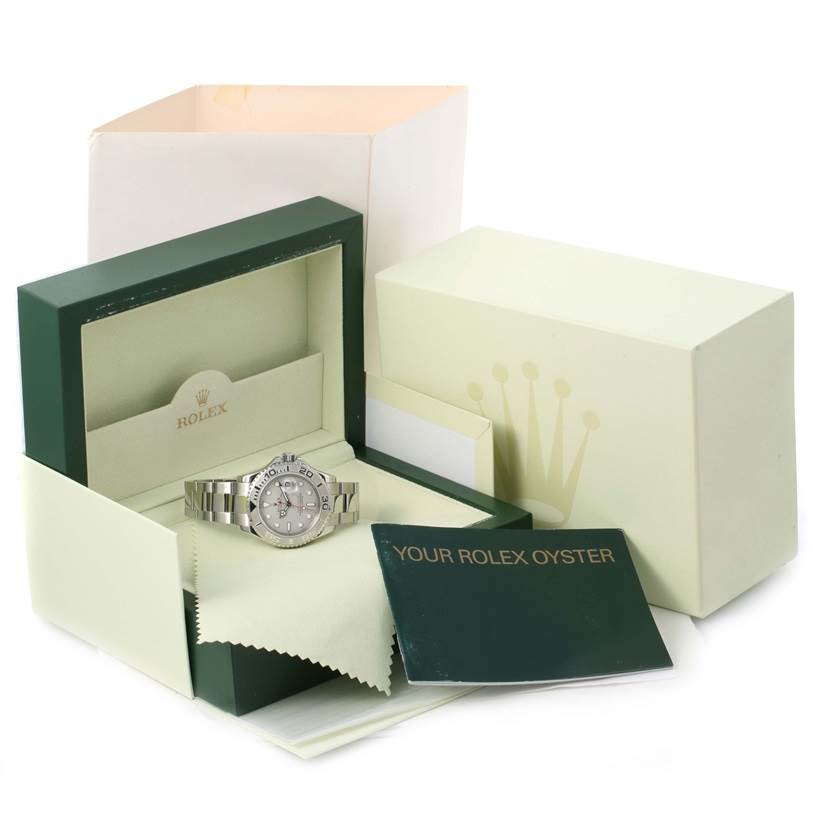 The Rolex Yacht-Master 16622 Men's Stainless Steel Silver Dial 16622 Men's Stainless Steel Silver Dial watch is shown inside its open box with a booklet and cleaning cloth.