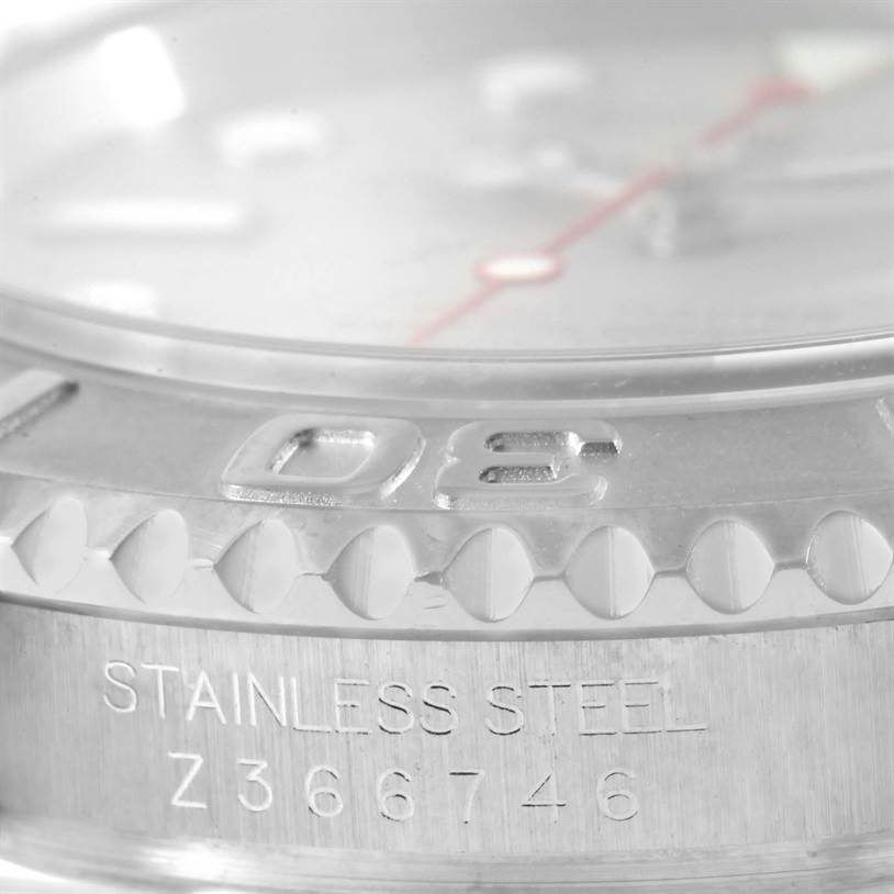 This close-up image of the Rolex Yacht-Master 16622 Men's Stainless Steel Silver Dial 16622 Men's Stainless Steel Silver Dial model shows part of the bezel and case with "STAINLESS STEEL" and a serial number inscribed.