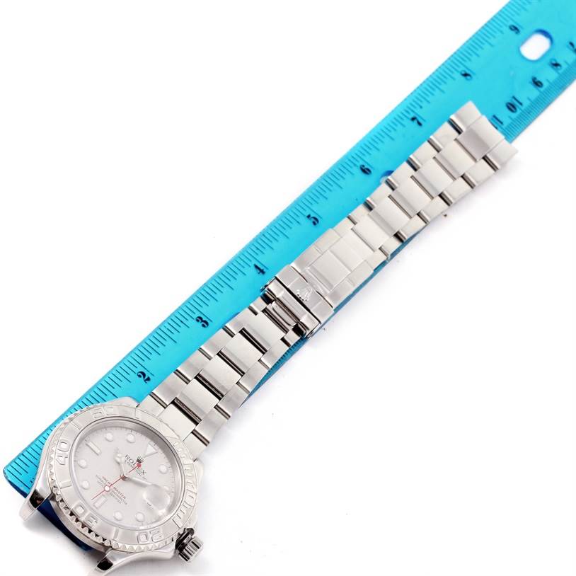 The image shows the face, bezel, crown, and bracelet of a Rolex Yacht-Master 16622 Men's Stainless Steel Silver Dial 16622 Men's Stainless Steel Silver Dial watch from an overhead angle next to a ruler.