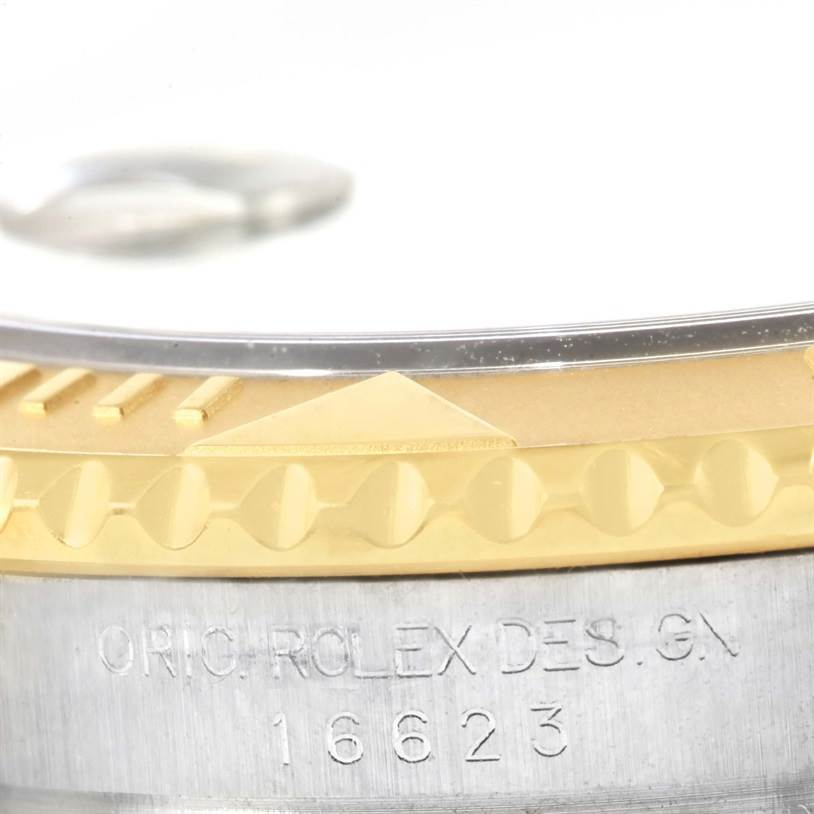 Close-up of the Rolex Yacht-Master 16623 Men's Stainless Steel Grey Dial 16623 Men's Stainless Steel Grey Dial's bezel showing the model number 16623 and part of the gold and steel construction.