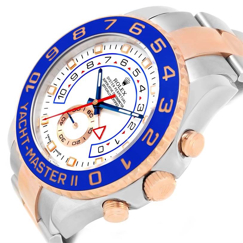 The image shows a Rolex Yacht-Master 116681 Men's Steel and Gold (two tone) White Dial 116681 Men's Steel and Gold (two tone) White Dial watch from a slight side angle, highlighting the blue bezel, white dial, and rose gold accents.