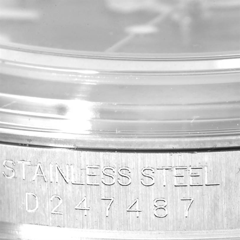 This close-up shot of the Rolex Yacht-Master 16623 Men's Stainless Steel Mother of Pearl Dial 16623 Men's Stainless Steel Mother of Pearl Dial watch shows part of the bezel and the engraved text indicating "STAINLESS STEEL" and a serial number.