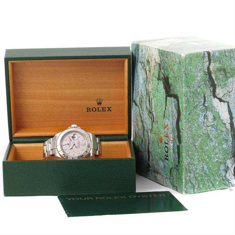 The image shows a Rolex Yacht-Master 16622 Men's Stainless Steel Silver Dial 16622 Men's Stainless Steel Silver Dial watch at an eye-level angle in a green and wooden Rolex box, next to the box lid and booklet.