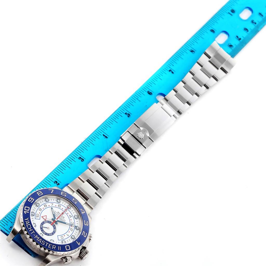 The image shows a Rolex Yacht-Master 116680 Men's Stainless Steel White Dial 116680 Men's Stainless Steel White Dial II watch laid flat with a blue ruler measuring its length.