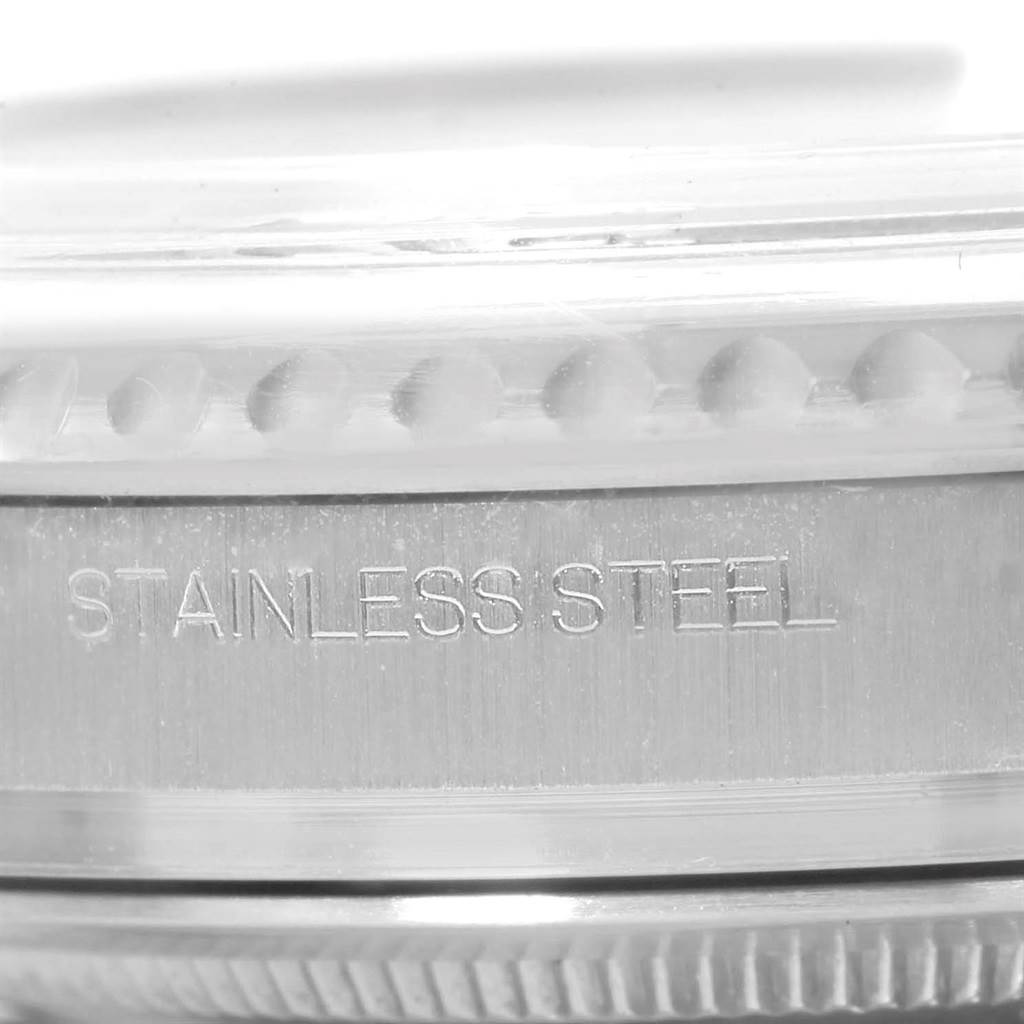 The image shows a close-up of the side view of the case and bezel of a Rolex Yacht-Master 116622 Men's Stainless Steel Blue Dial 116622 Men's Stainless Steel Blue Dial watch with "STAINLESS STEEL" engraved.