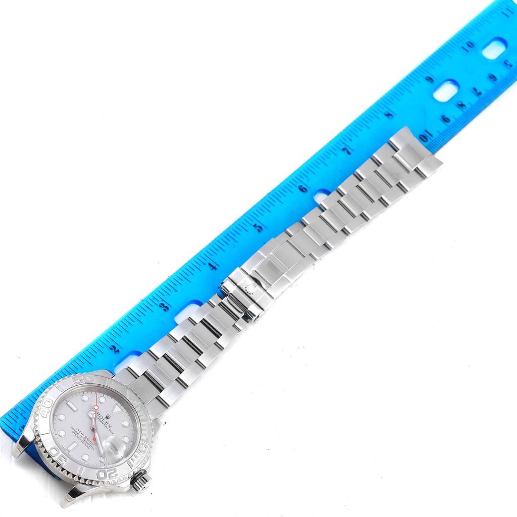 The image shows a Rolex Yacht-Master 16622 Men's Stainless Steel Silver Dial 16622 Men's Stainless Steel Silver Dial watch laid flat next to a blue ruler, displaying the face and full length of the metal bracelet.