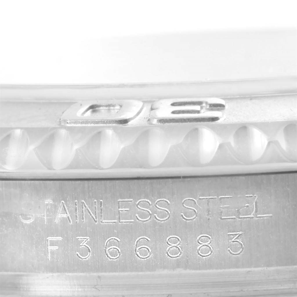 Close-up of a Rolex Yacht-Master 16622 Men's Stainless Steel Silver Dial 16622 Men's Stainless Steel Silver Dial watch, showing its engraved bezel and part of its case with serial number.