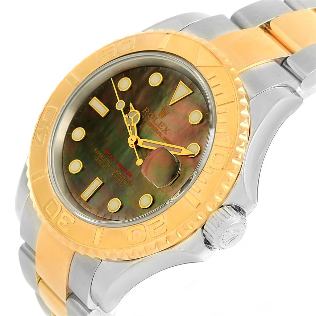 The image shows a close-up angle of a Rolex Yacht-Master 16623 Men's Stainless Steel Mother of Pearl Dial 16623 Men's Stainless Steel Mother of Pearl Dial watch highlighting its gold bezel, dial, and part of the strap.